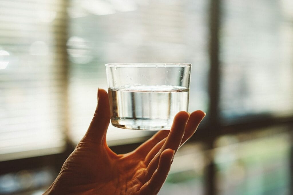 Glass of water used to mix MiraLAX powder